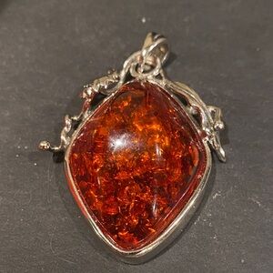 Silver Tone Pendant with Amber Tone     Does    not Glow.